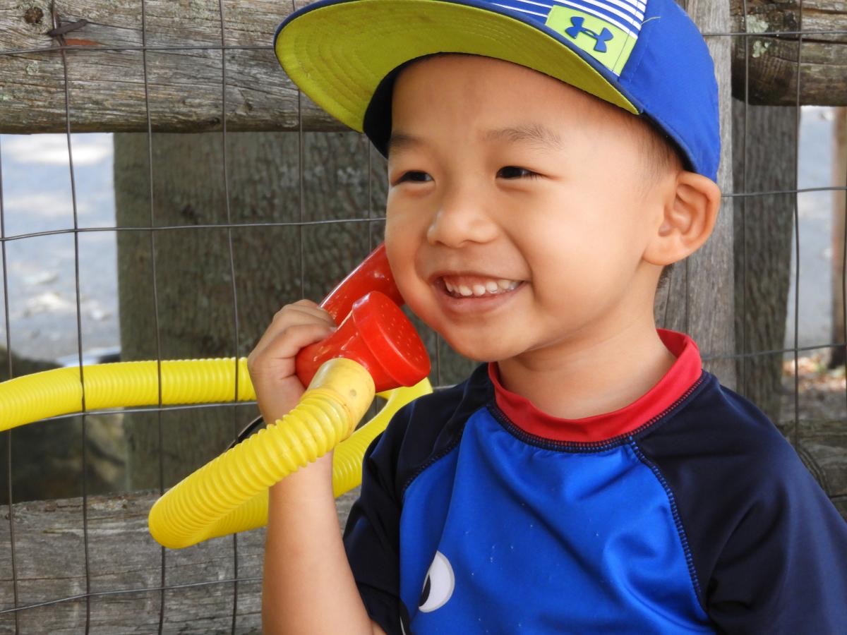 A child grinning during free play at Lexington Playcare Center
